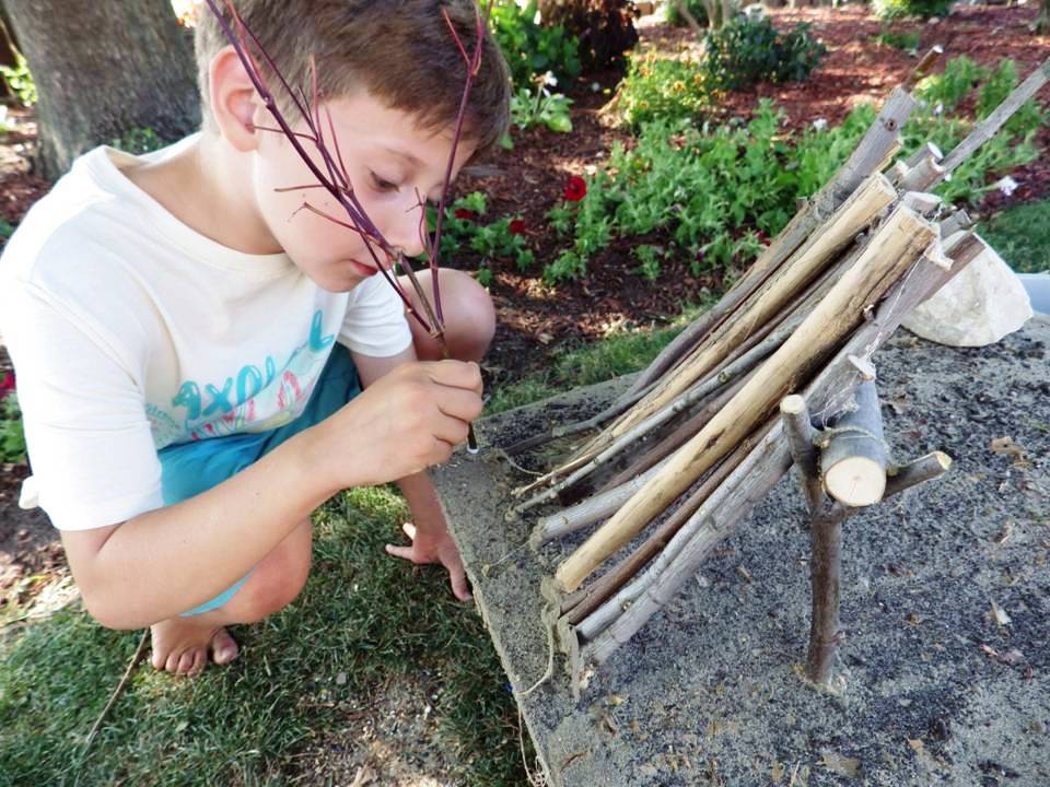 BOY PUTTING TREES IN DIORAMA