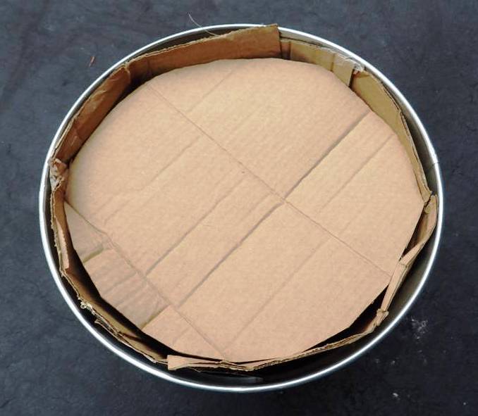 CARDBOARD LID ON TOP OF CAN