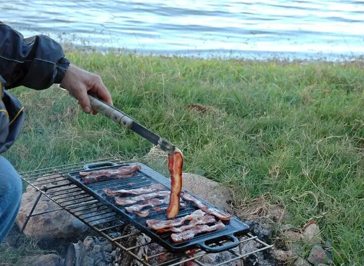 Bacon On Griddle Over Fire