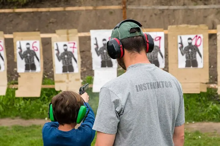 Child and Instructor at Shooting Range