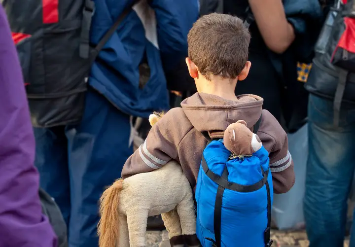 Child Refugee Carrying Toys