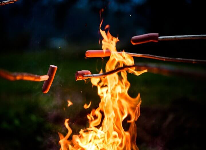 Cooking Hot Dogs on Sticks over a Fire