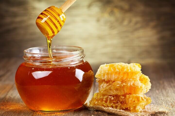 Honeycombs Next To Honey Jar