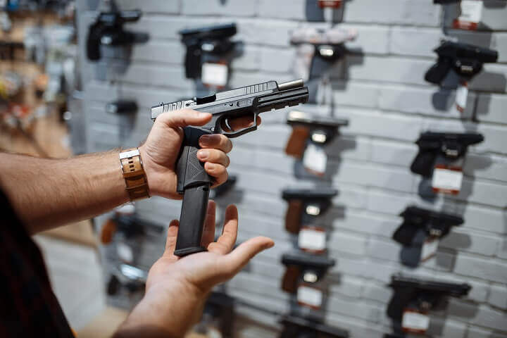 Man Choosing New Handgun In Shop