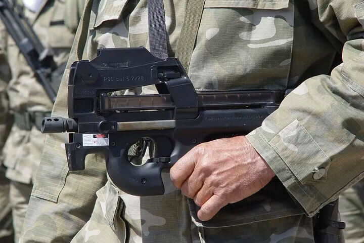 Man Holding Submachine Gun