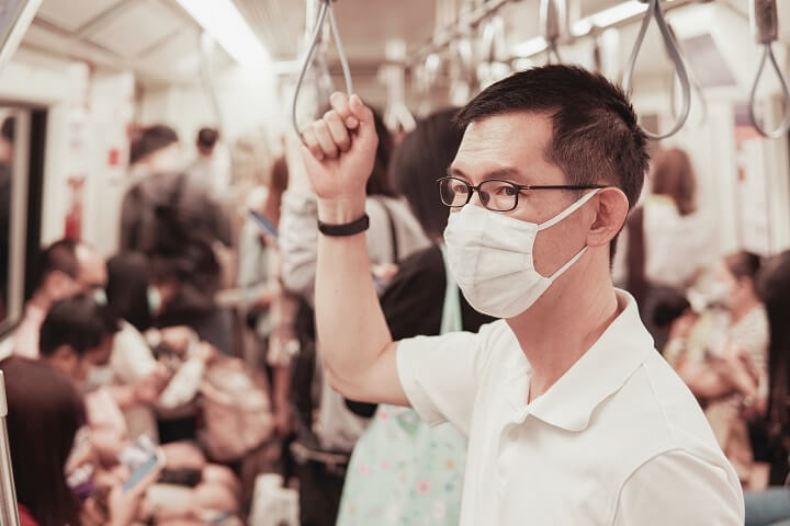 Man Wearing Flu Mask On Subway