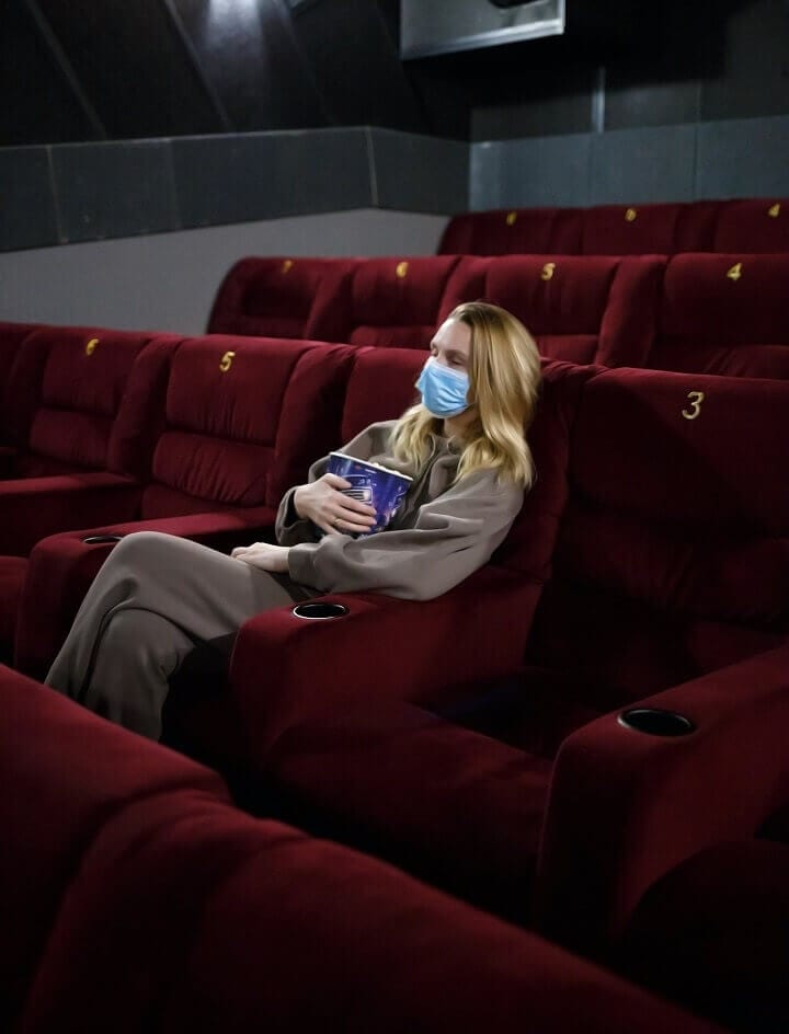 Young Woman Wearing Mask Alone In Theater